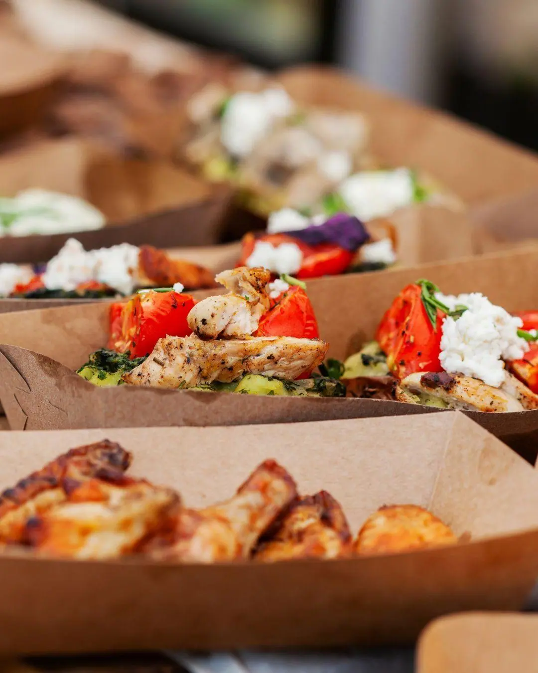 Grilled chicken and salad served in kraft food boats